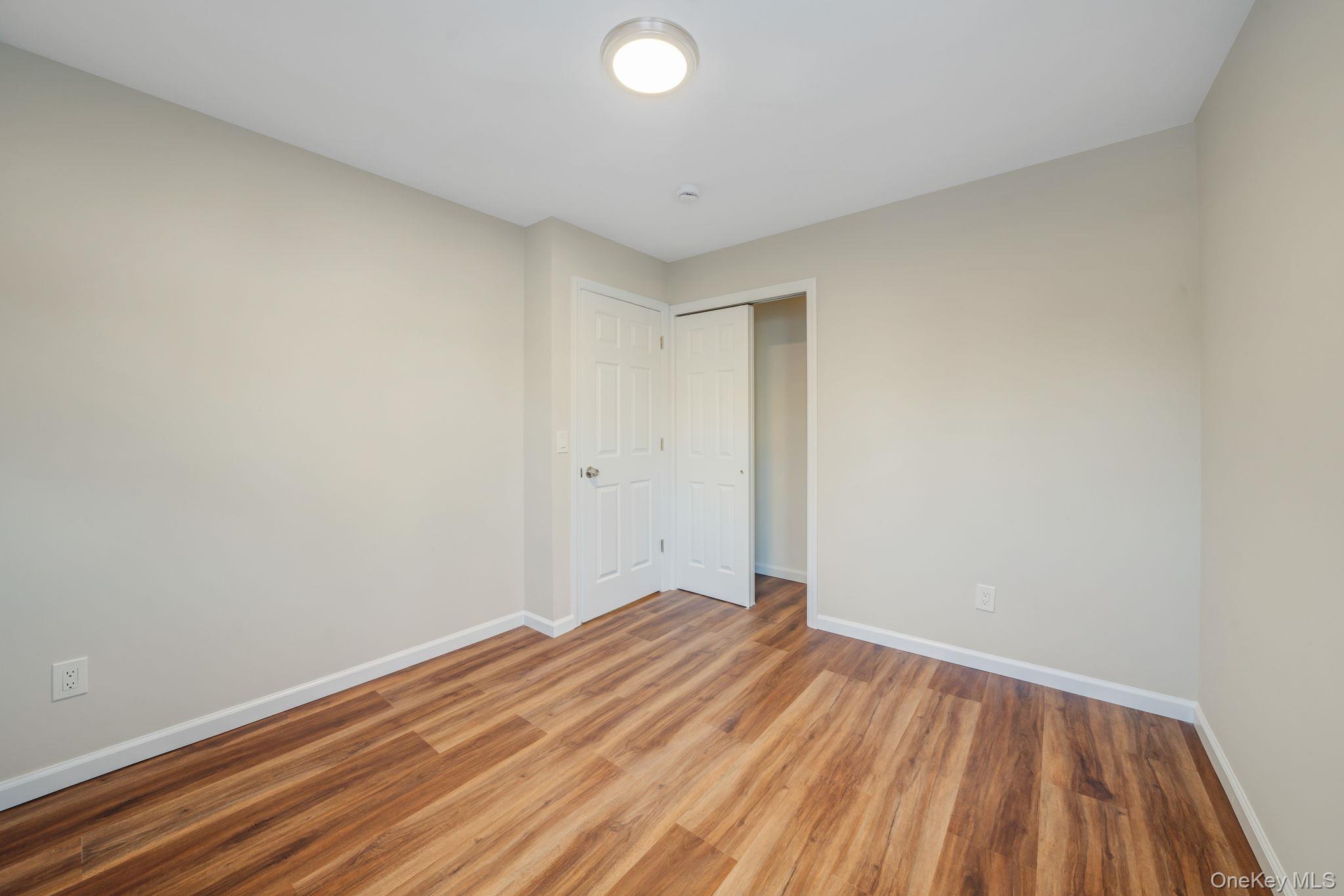 247 Rider Avenue Patchogue, NY 11772 - Photo 14 of 25 a view of room with wooden floor