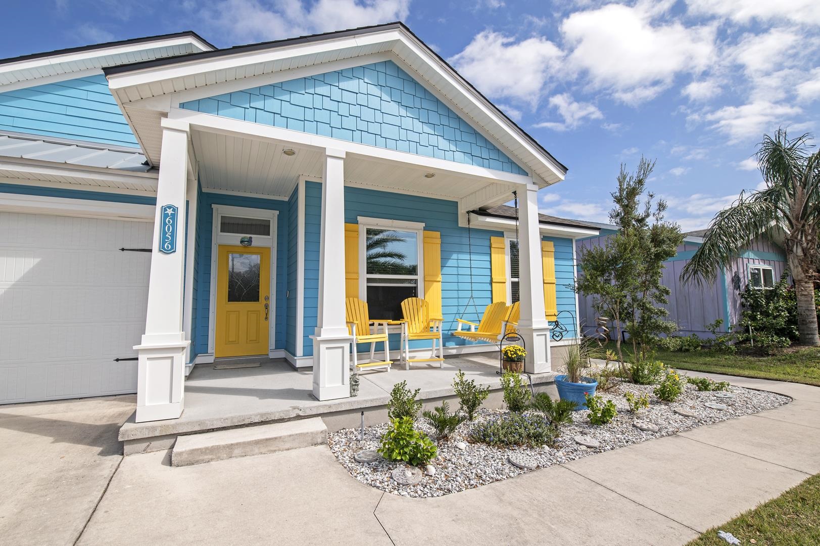 View of exterior entry featuring covered porch and a garage