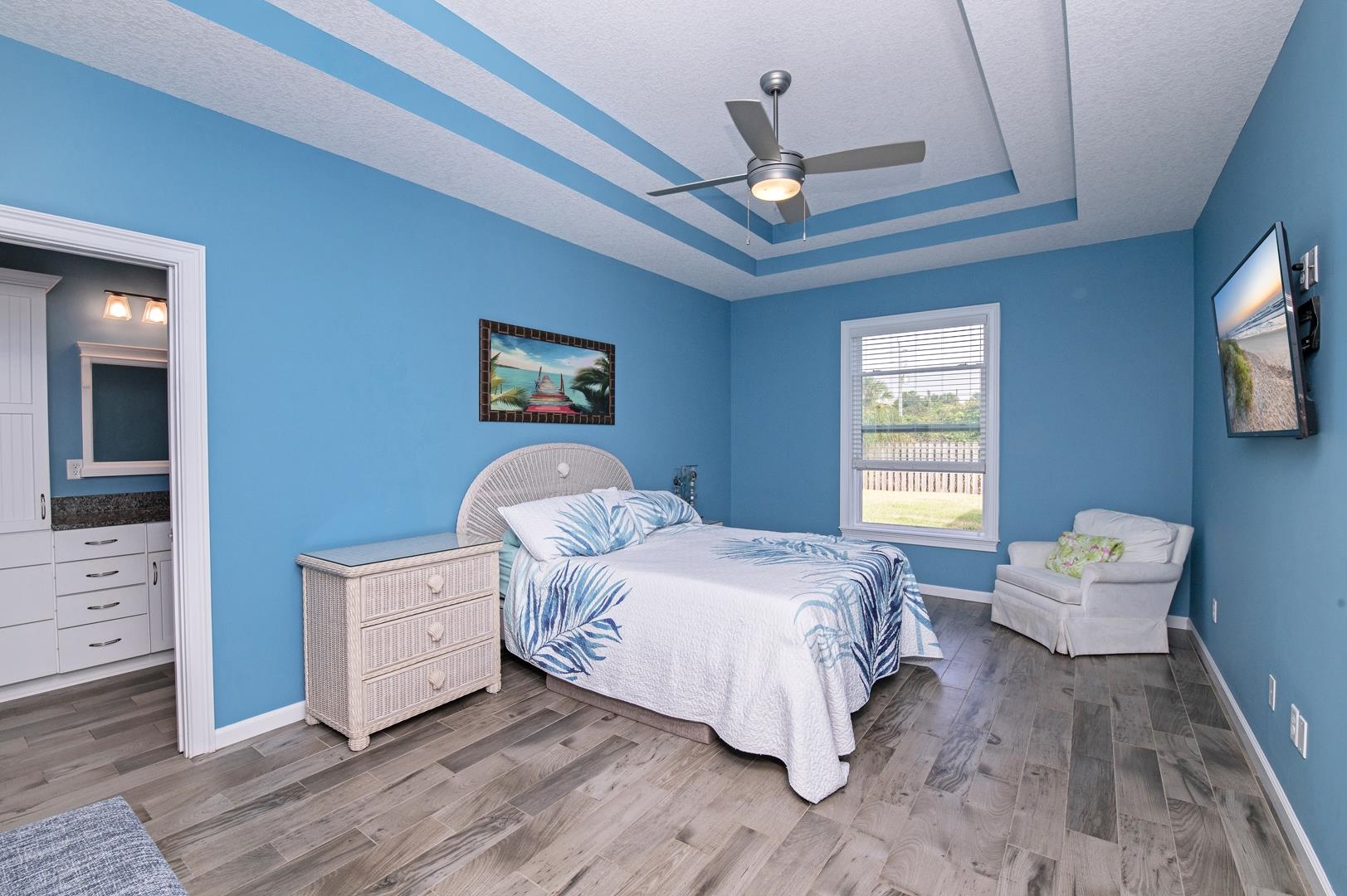 6056 Costanero Road St. Augustine, FL 32080 - Photo 10 of 30 Bedroom with wood finished floors, ceiling fan, a tray ceiling, and a textured ceiling