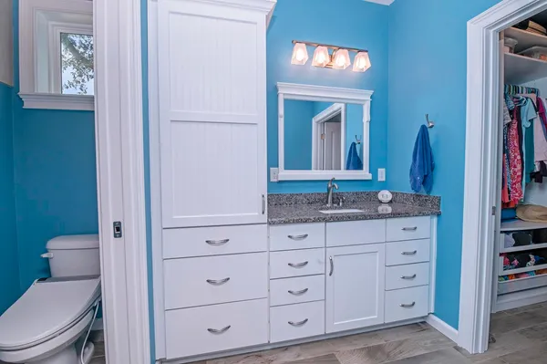 a view of walk in closet with clothes
