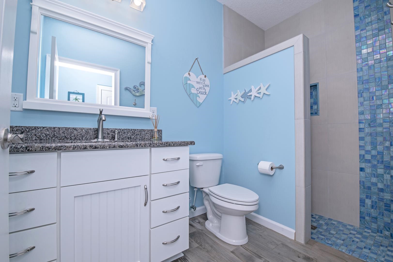 6056 Costanero Road St. Augustine, FL 32080 - Photo 14 of 30 Bathroom featuring walk in shower, light wood finished floors, and vanity