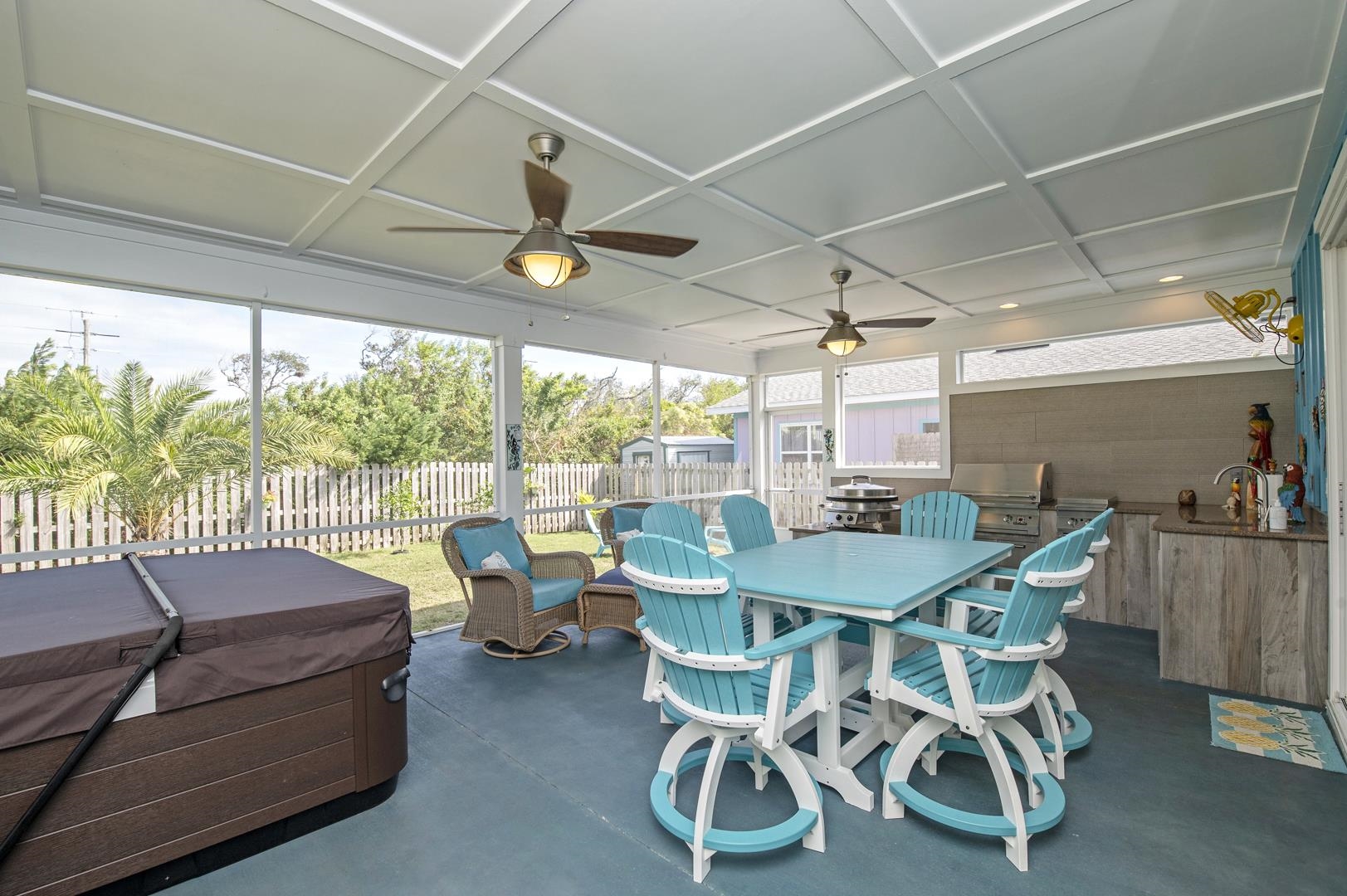 6056 Costanero Road St. Augustine, FL 32080 - Photo 22 of 30 Fenced backyard featuring ceiling fan, a hot tub, a patio, area for grilling, and outdoor dining area