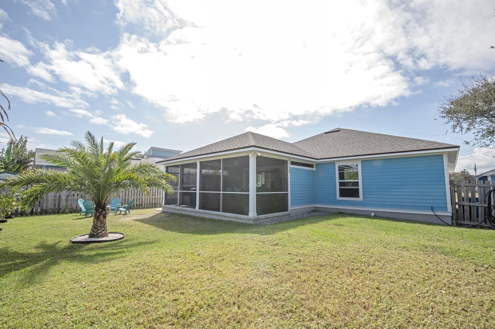 6056 Costanero Road St. Augustine, FL 32080 - Photo 25 of 30 Back of property featuring a sunroom and a shingled roof
