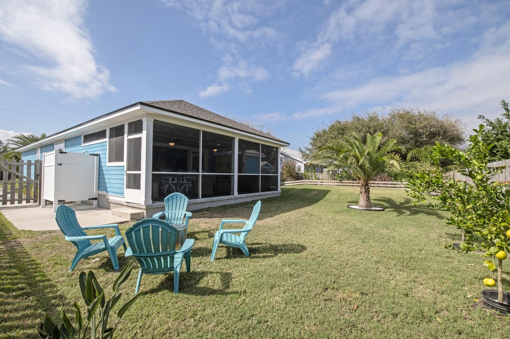 6056 Costanero Road St. Augustine, FL 32080 - Photo 26 of 30 Back of house with a sunroom, roof with shingles, a gate, and a patio