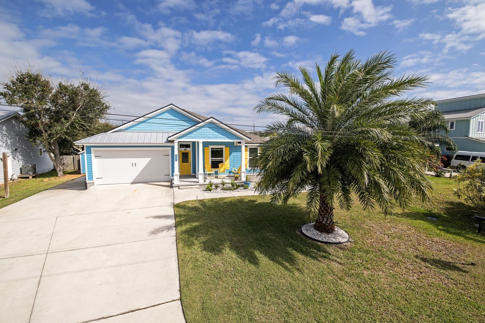 6056 Costanero Road St. Augustine, FL 32080 - Photo 4 of 30 View of front of house with driveway, a garage, a front lawn, a metal roof, and a porch