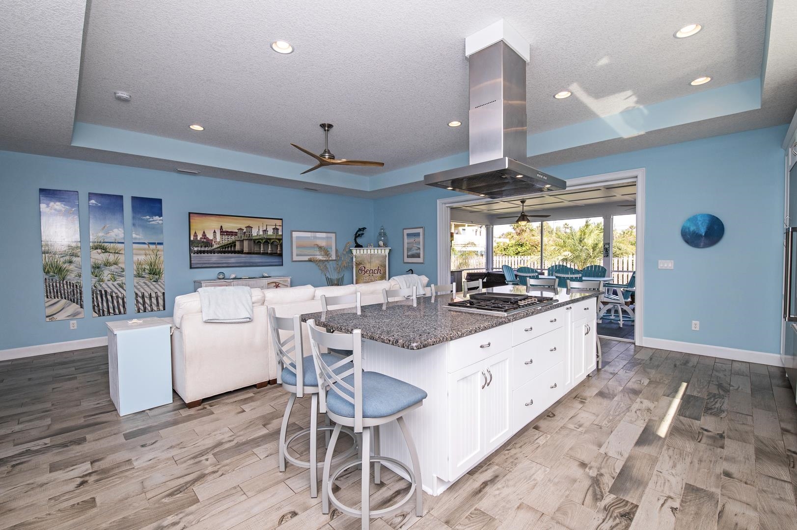 6056 Costanero Road St. Augustine, FL 32080 - Photo 30 of 30 Kitchen with a kitchen breakfast bar, a raised ceiling, a ceiling fan, open floor plan, and island exhaust hood