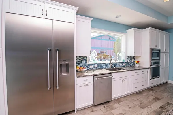 a large kitchen with a table and chairs