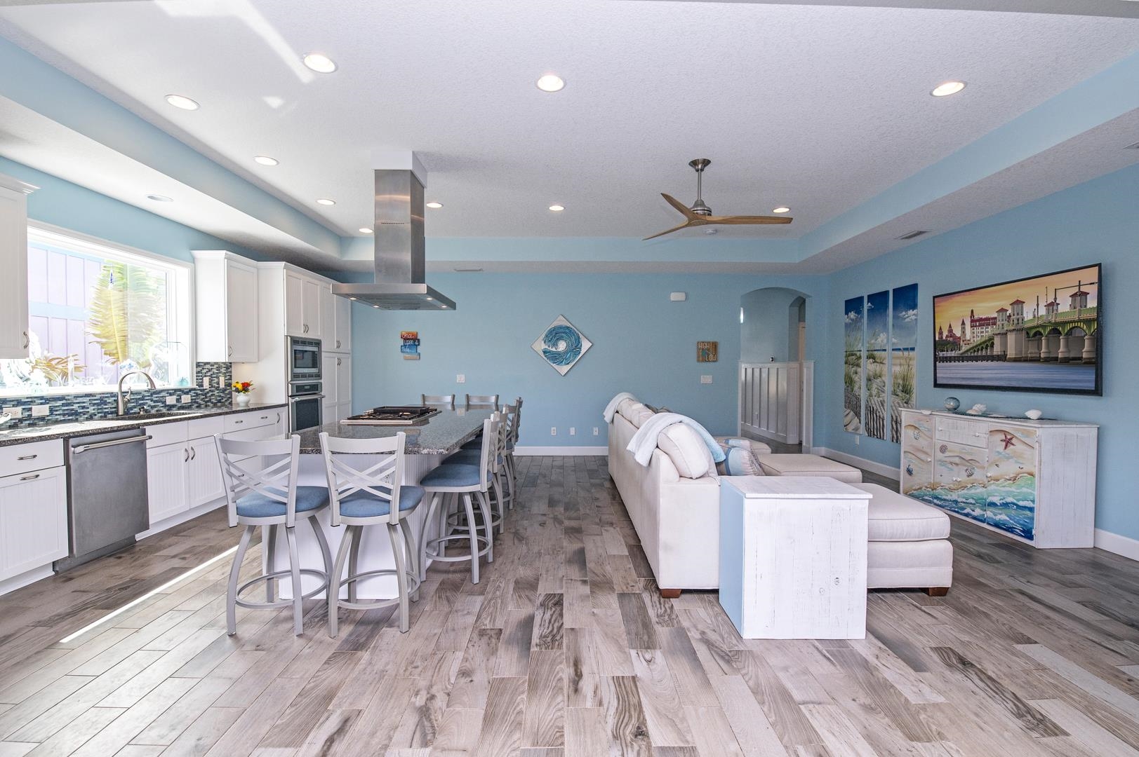 6056 Costanero Road St. Augustine, FL 32080 - Photo 7 of 30 Living area with a raised ceiling, arched walkways, light wood-style floors, ceiling fan, and recessed lighting