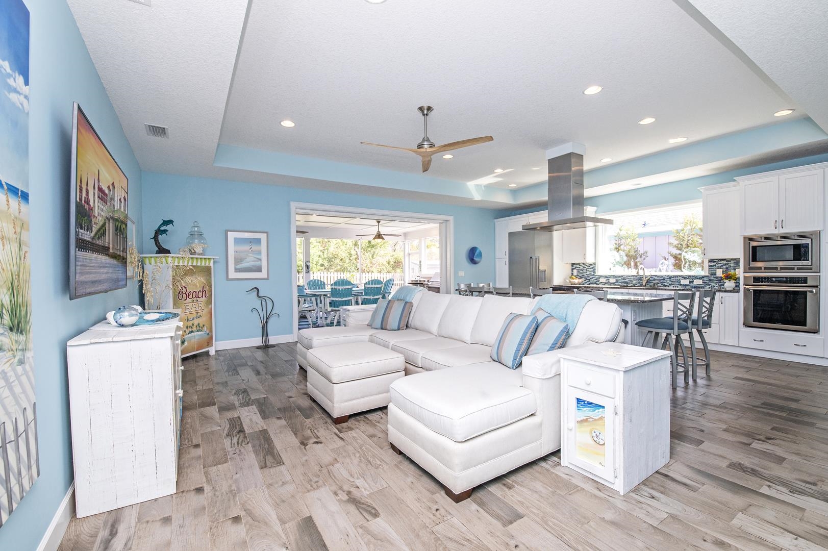 6056 Costanero Road St. Augustine, FL 32080 - Photo 8 of 30 Living room with a tray ceiling, ceiling fan, light wood-style flooring, and recessed lighting