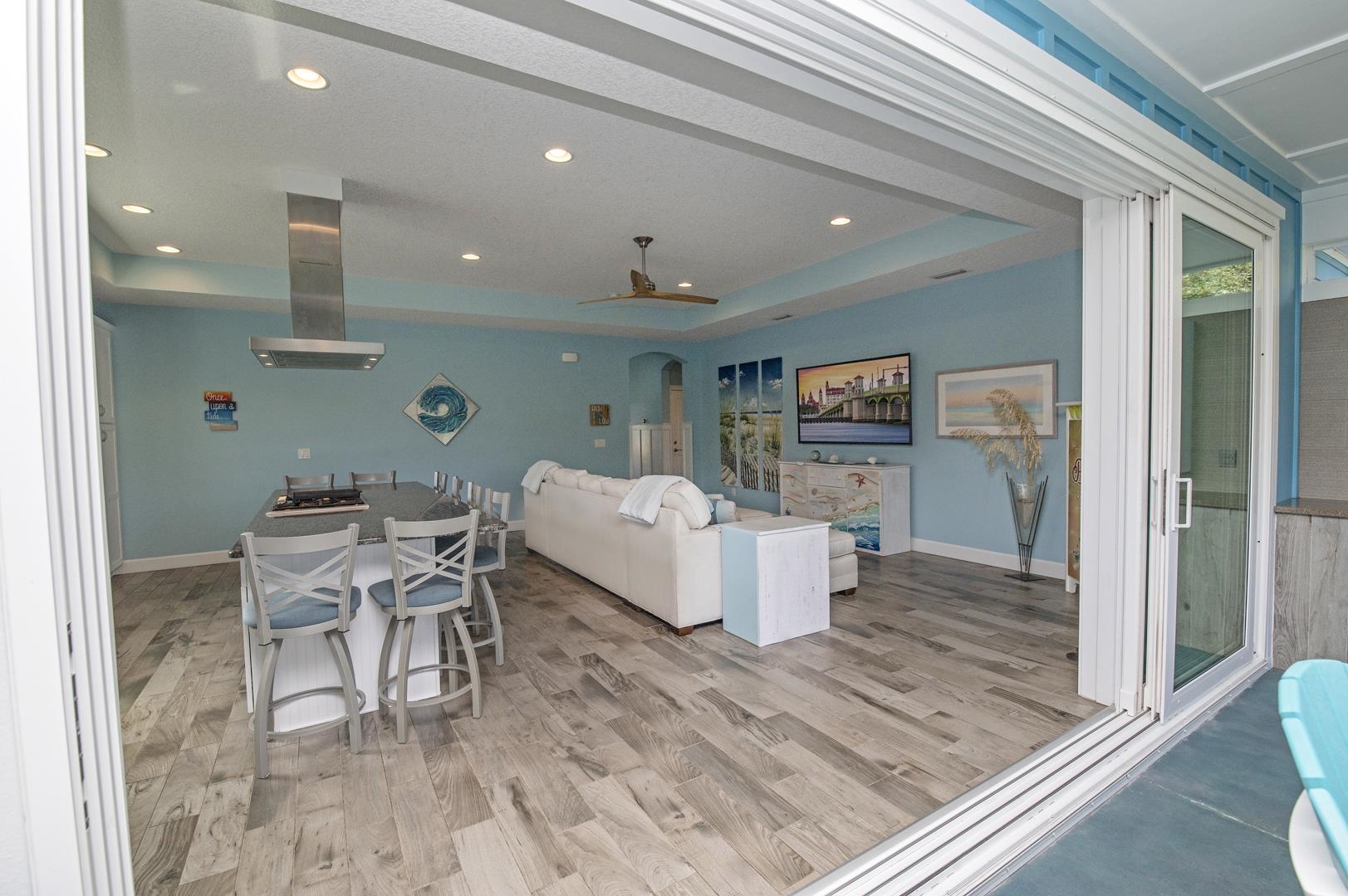 6056 Costanero Road St. Augustine, FL 32080 - Photo 9 of 30 Living area featuring a tray ceiling, arched walkways, light wood finished floors, ceiling fan, and recessed lighting
