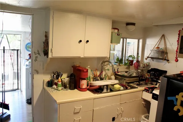 a kitchen with a sink appliances and cabinets