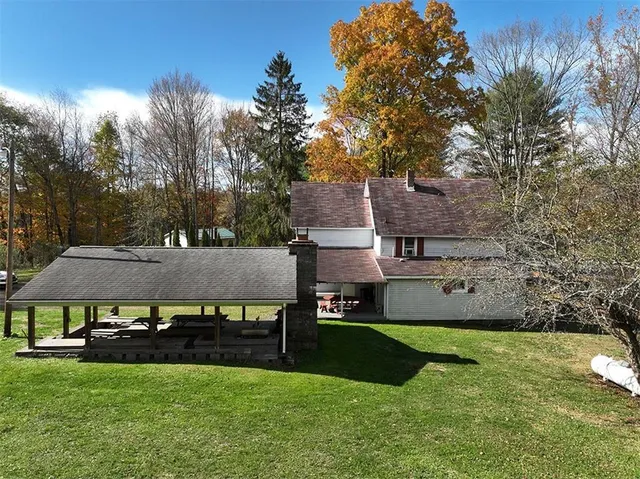 a front view of a house with yard and green space
