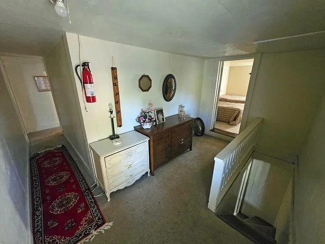 a bedroom with two beds and painting on the wall