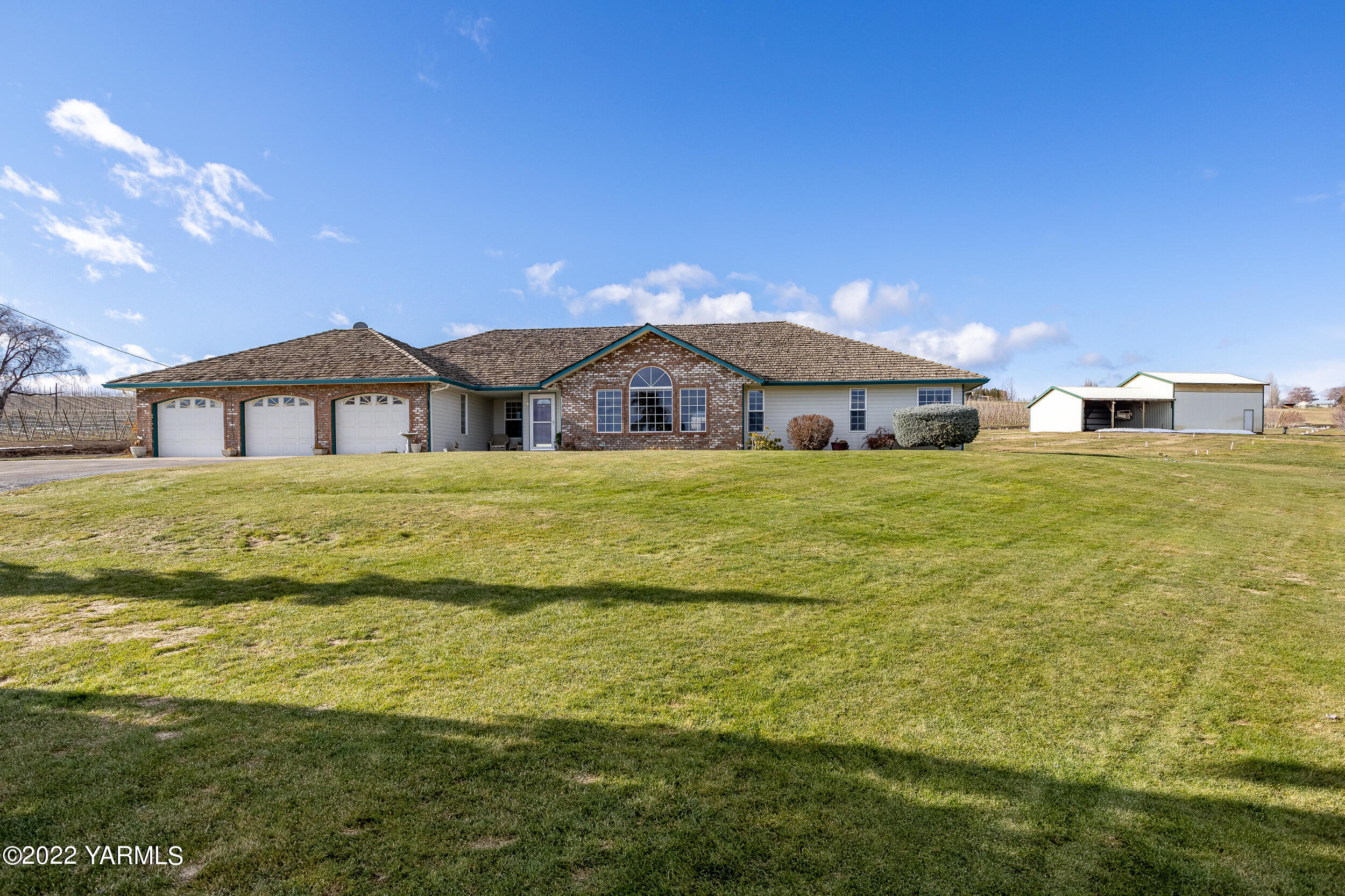 a large house with a big yard and large trees