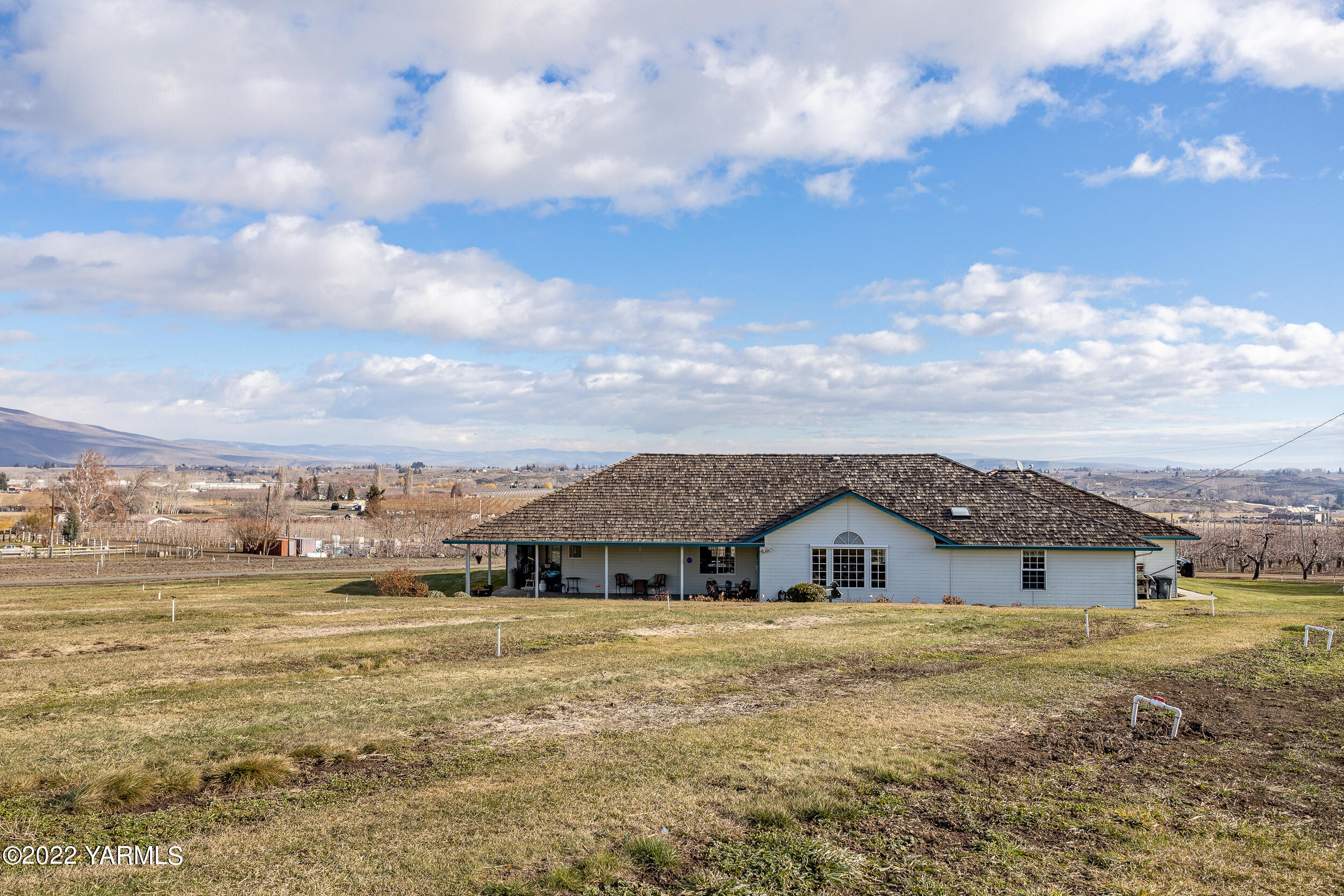 200 Nash Road Tieton, WA 98947 - Photo 28 of 29 a view of a big house with a big yard and large trees