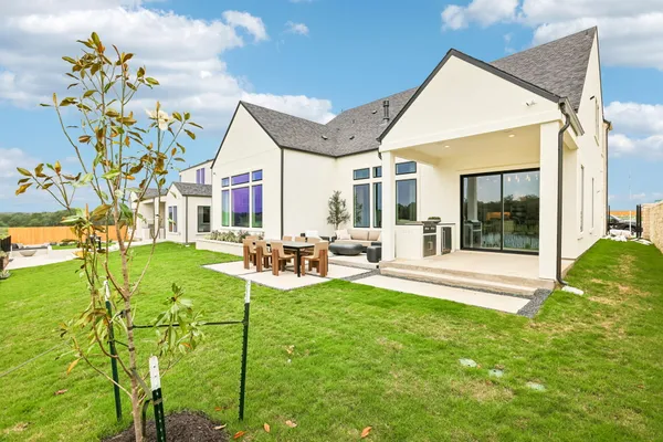 a view of a house with backyard porch and furniture