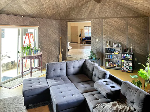 a living room with furniture and a floor to ceiling window