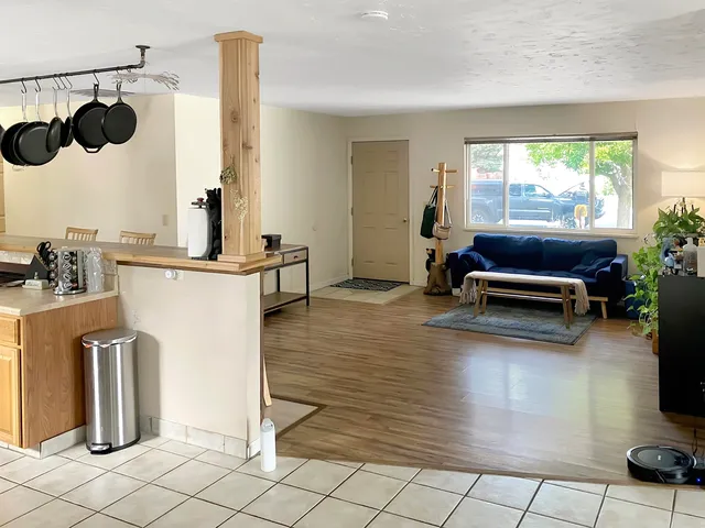 a living room with furniture window and wooden floor
