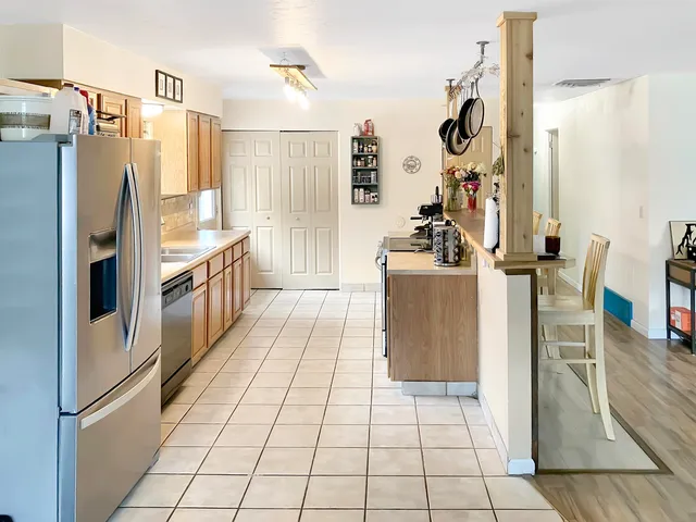 a kitchen with stainless steel appliances granite countertop a refrigerator and a stove