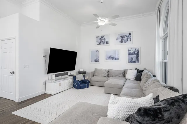 a bedroom with a bed and large windows