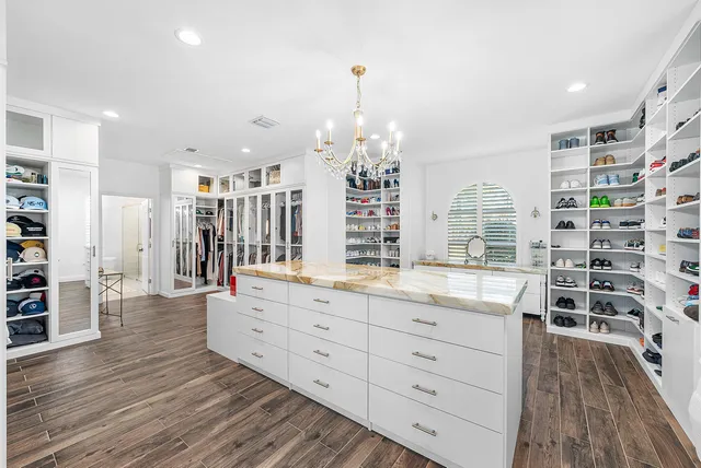 a view of a room with wooden floor and windows