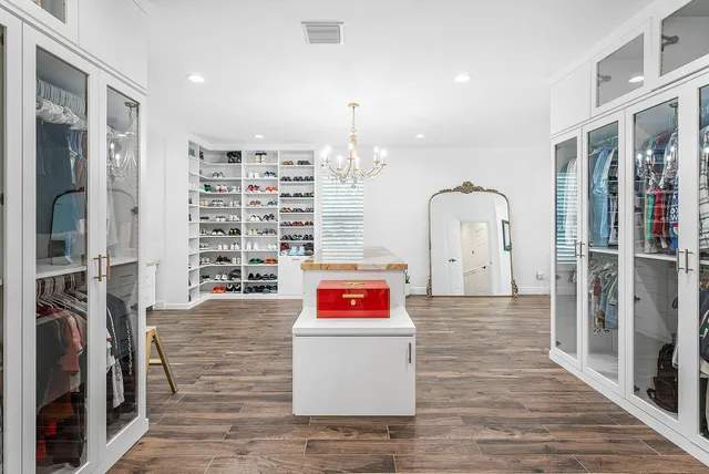 a bedroom with a bed and a flat tv screen on dresser