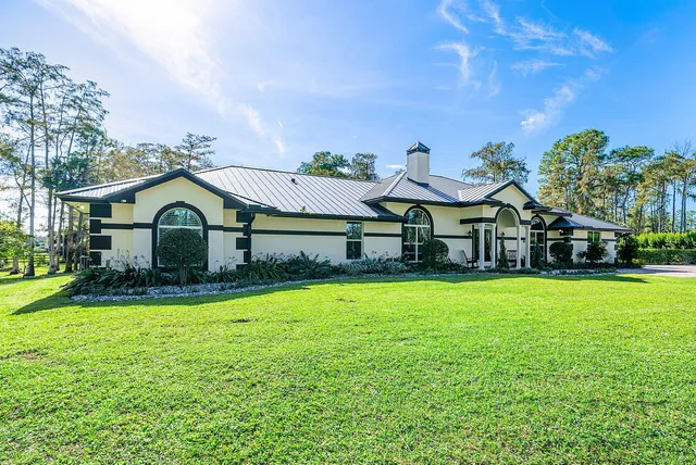 a view of a dining room with furniture a chandelier and wooden floor