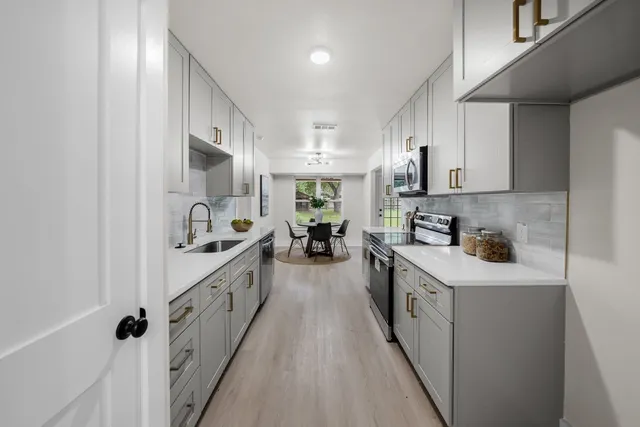 a kitchen with kitchen island granite countertop lots of counter top space and sink