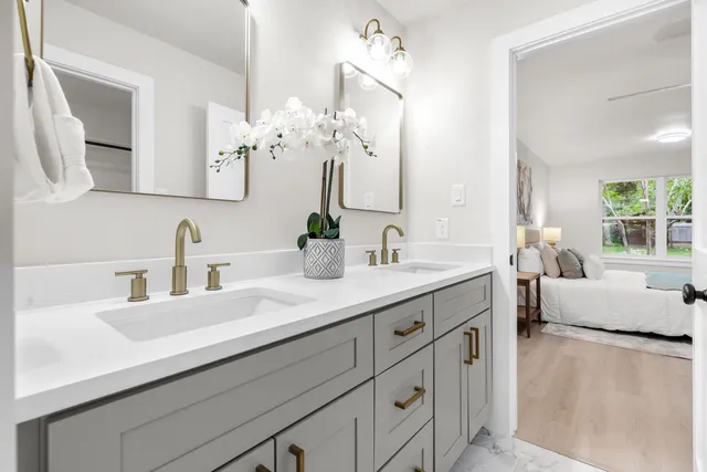 a bathroom with a double vanity sink mirror and
