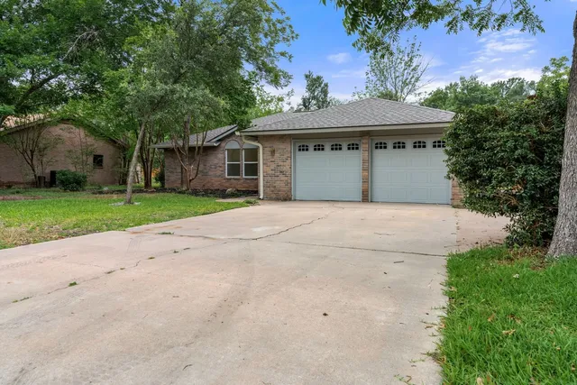 a front view of a house with a yard and a garage