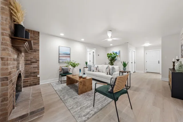 a living room with furniture a fireplace and a flat screen tv