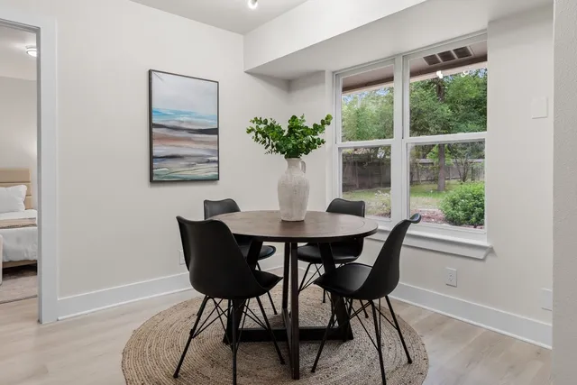 a dining room with furniture and wooden floor