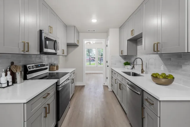 a kitchen with stainless steel appliances granite countertop a sink and stove