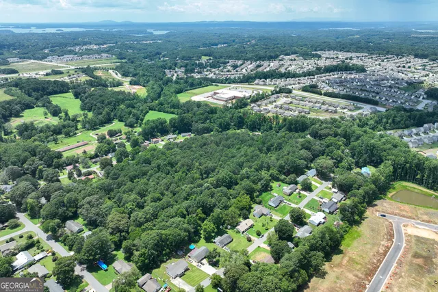 an aerial view of residential houses with outdoor space and street view