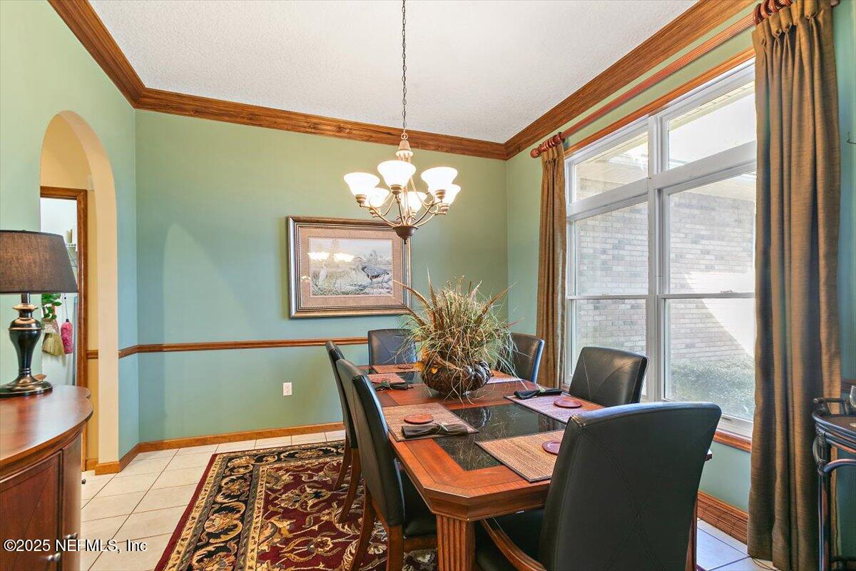 85232 Amanda Court Yulee, FL 32097 - Photo 12 of 42 a view of a dining room with furniture a chandelier and wooden floor