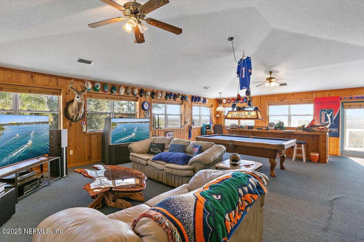 85232 Amanda Court Yulee, FL 32097 - Photo 25 of 42 a living room with patio furniture and a flat screen tv