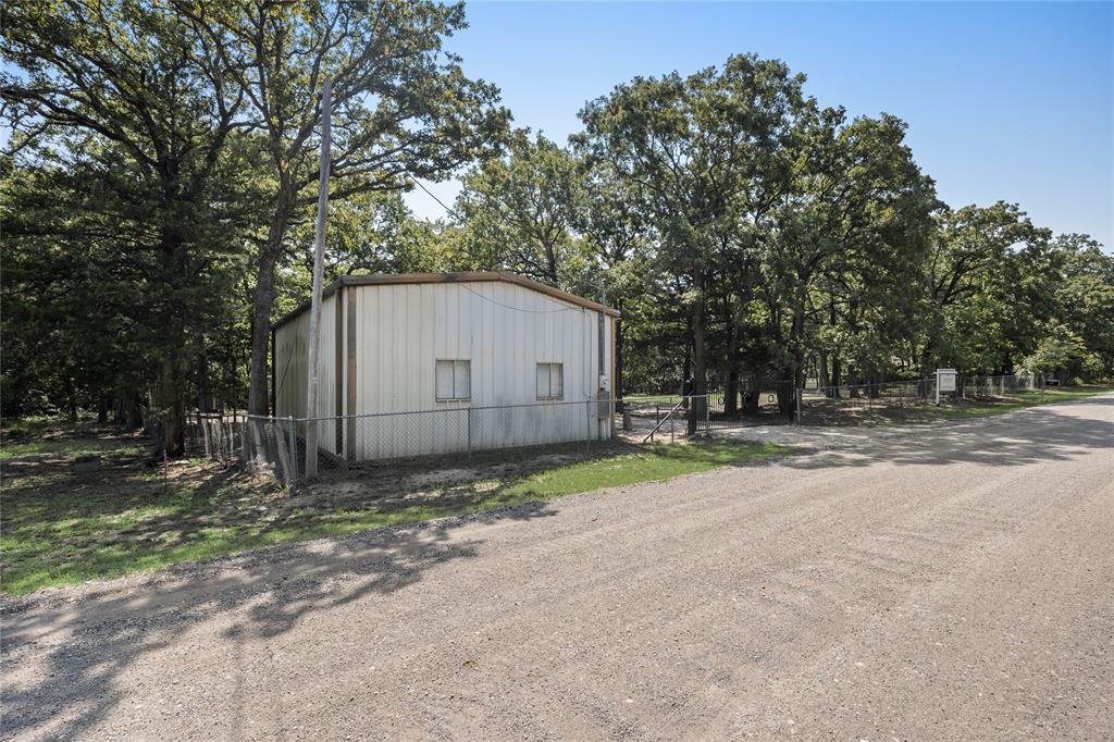 7243 County Road 3512 Quinlan, TX 75474 - Photo 14 of 14 View of outbuilding featuring view of scattered trees