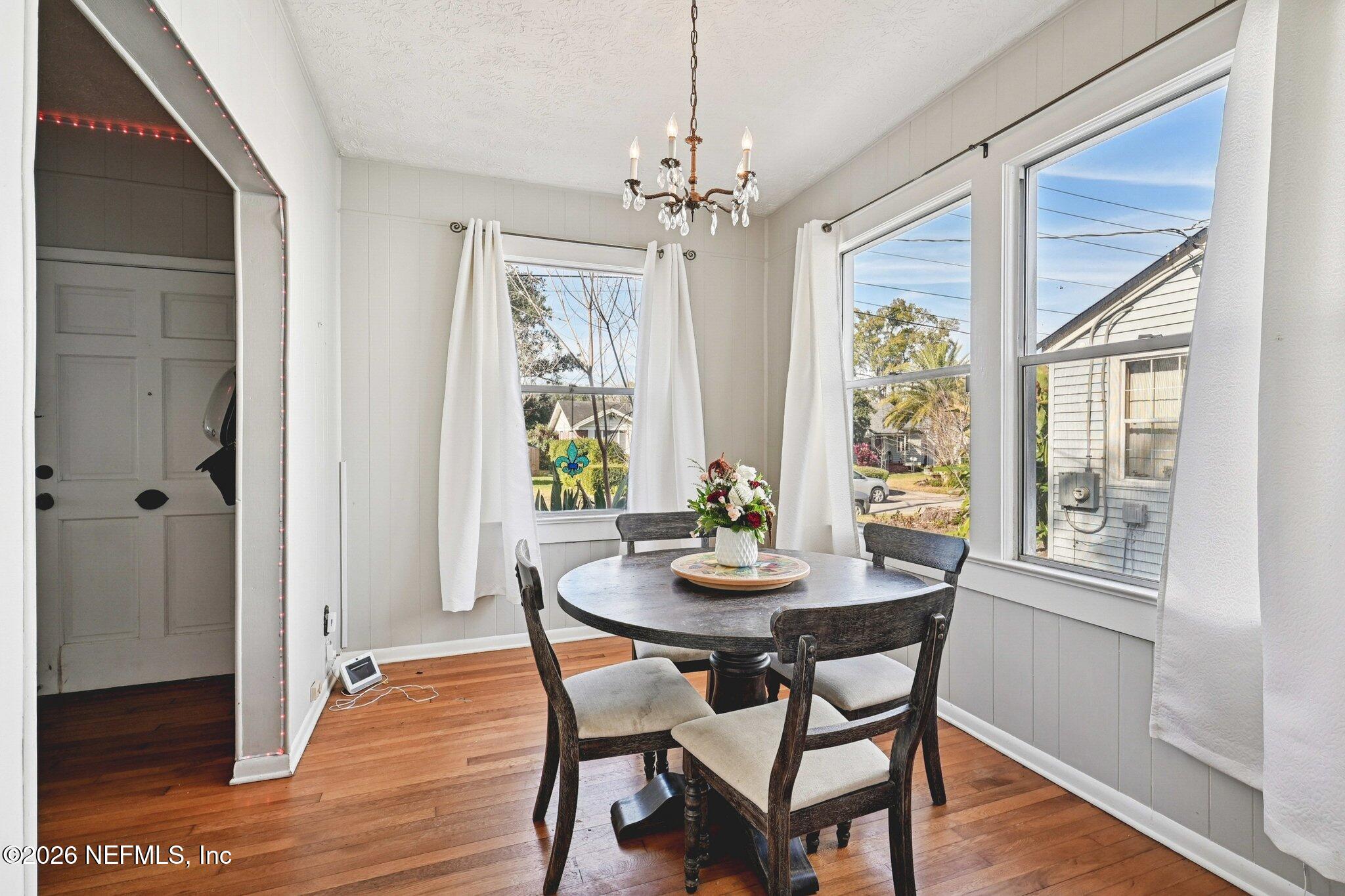 1021 Old Hickory Road Jacksonville, FL 32207 - Photo 15 of 42 a dining room with furniture a chandelier and wooden floor