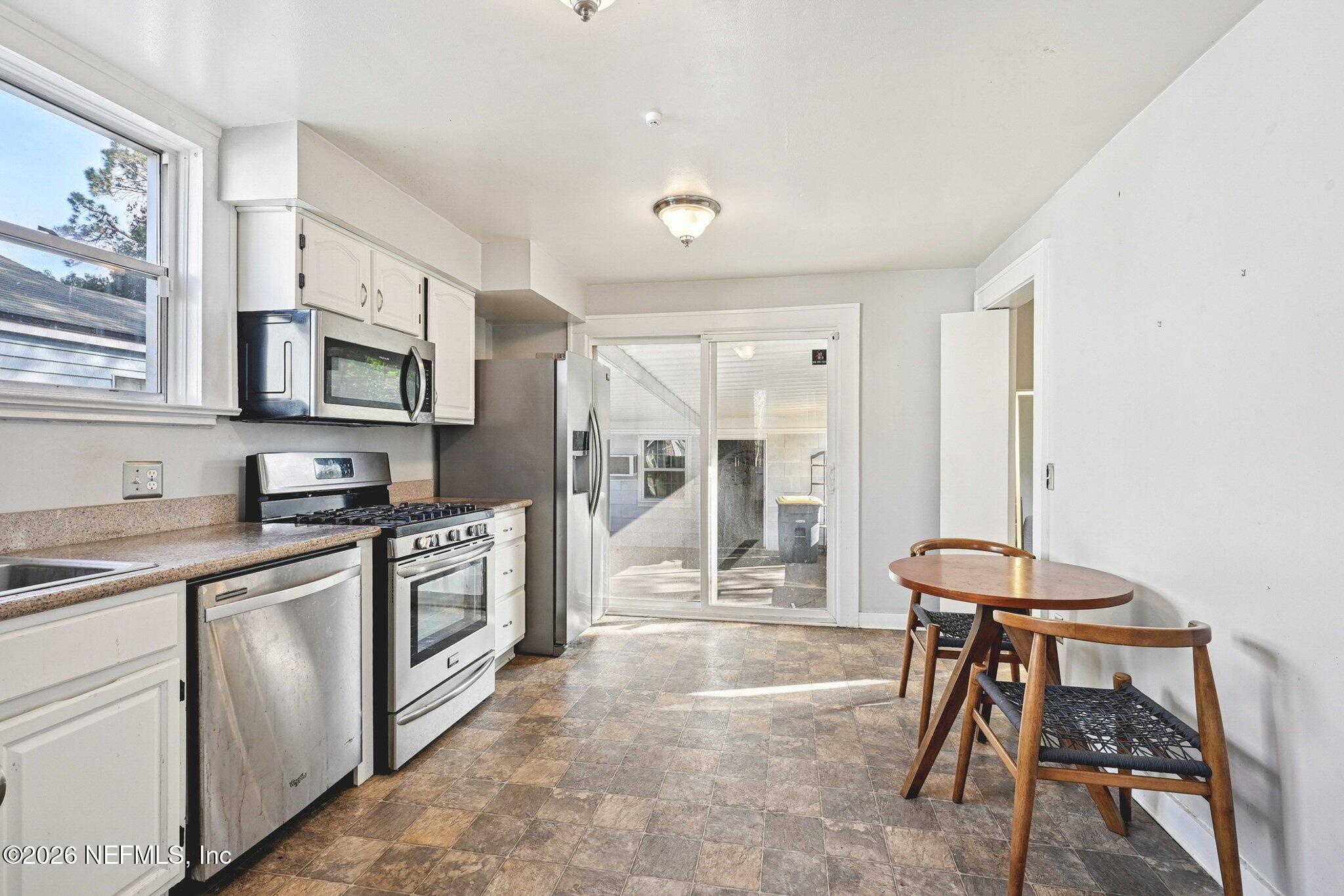 1021 Old Hickory Road Jacksonville, FL 32207 - Photo 16 of 42 a kitchen with stainless steel appliances granite countertop a stove top oven a sink dishwasher and white cabinets