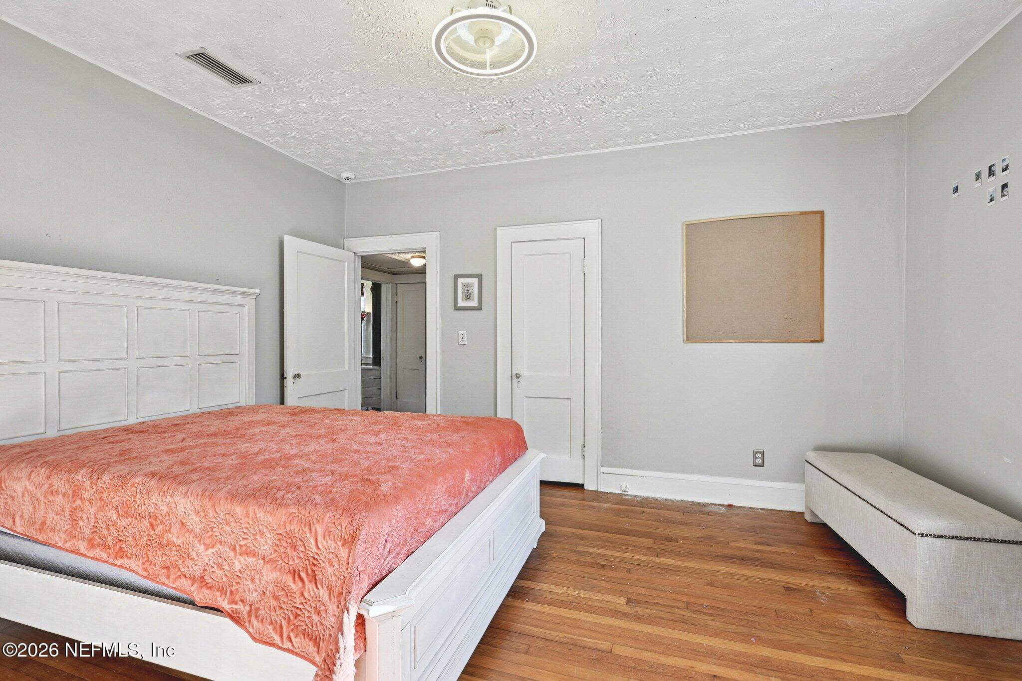 1021 Old Hickory Road Jacksonville, FL 32207 - Photo 25 of 42 a bedroom with a bed and a wooden floor