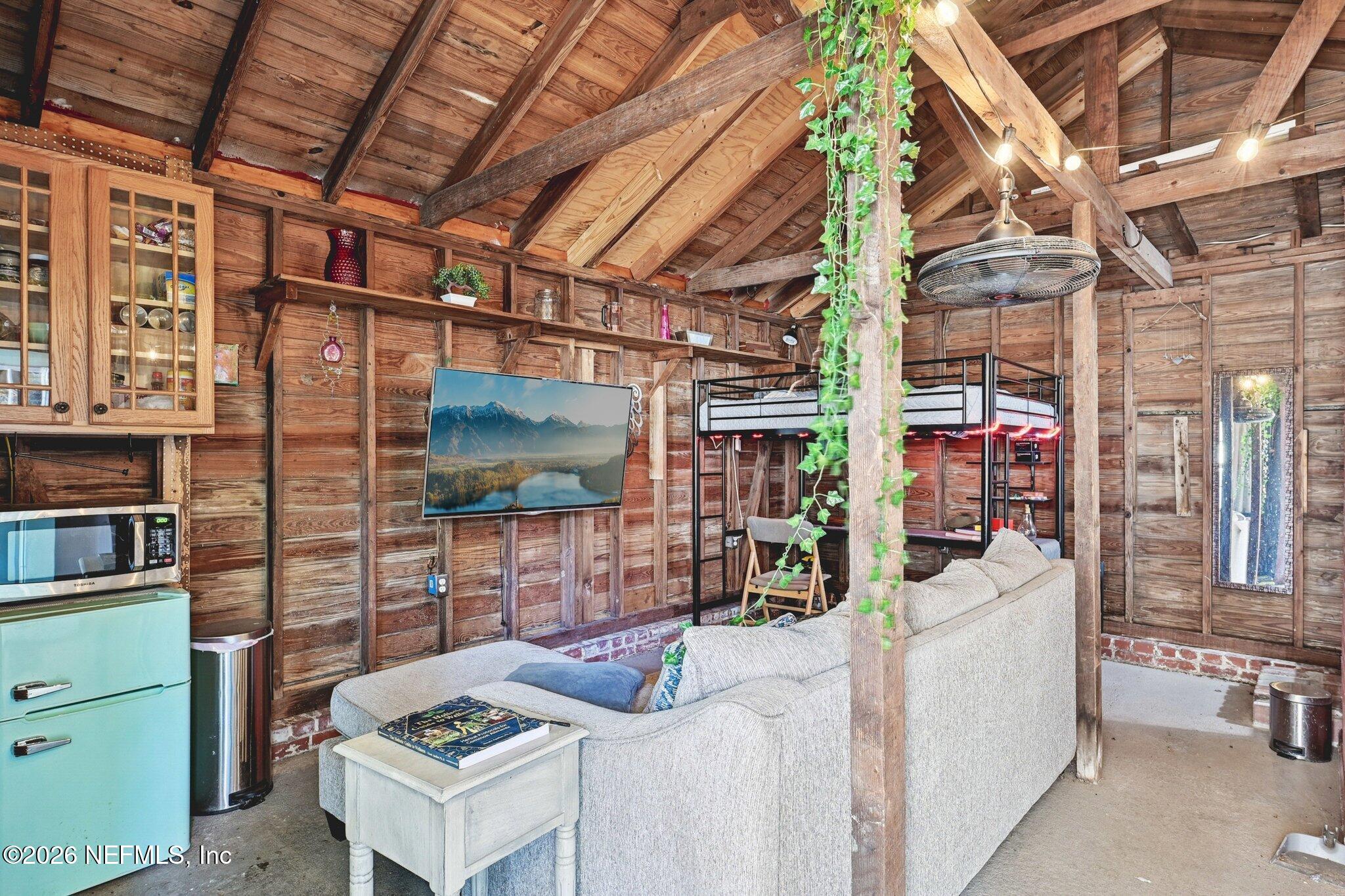 1021 Old Hickory Road Jacksonville, FL 32207 - Photo 30 of 42 a living room with furniture a flat screen tv and a table
