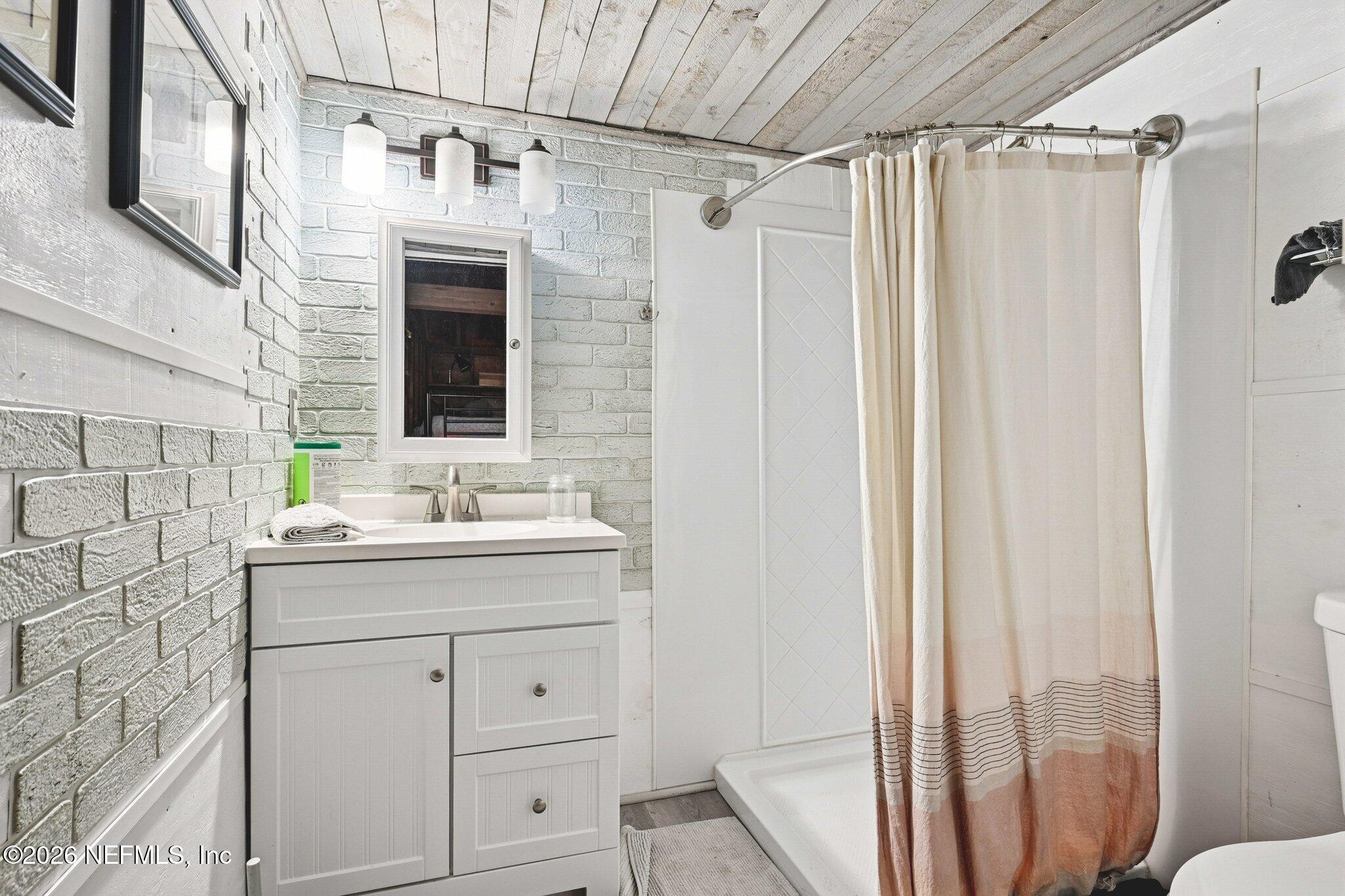 1021 Old Hickory Road Jacksonville, FL 32207 - Photo 33 of 42 a bathroom with a sink and mirror