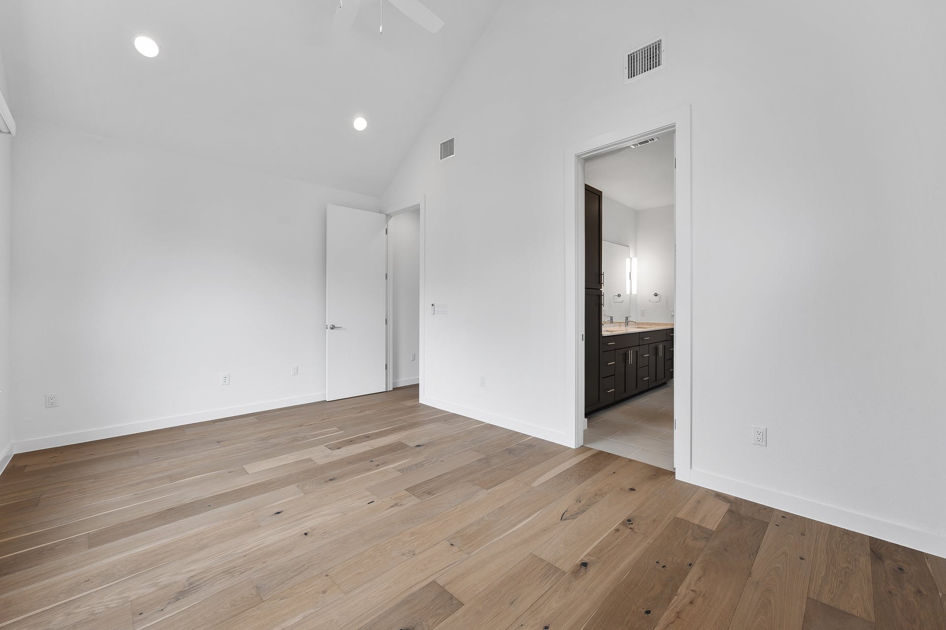 900 South 2nd Street, Unit 15 Austin, TX 78704 - Photo 16 of 31 an empty room with wooden floor and mirror