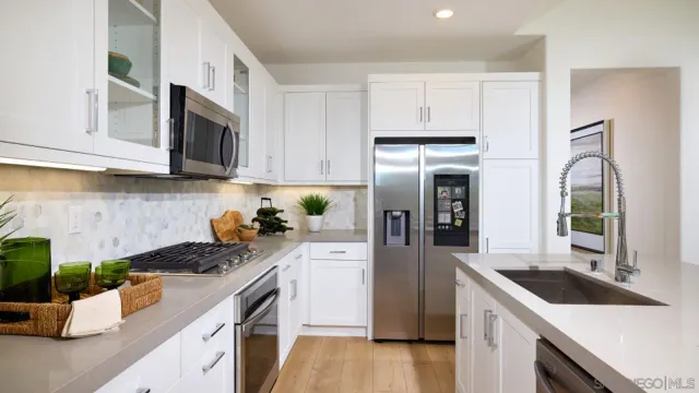 a kitchen with a sink stove and refrigerator