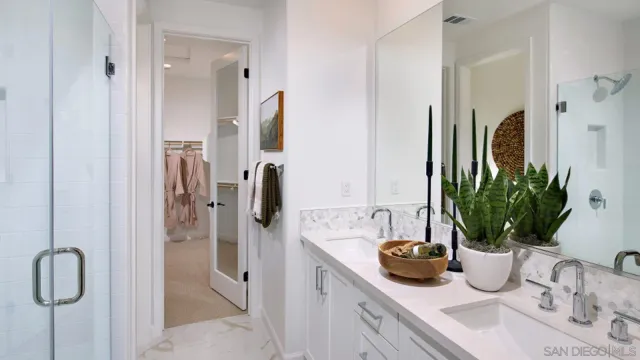 a bathroom with a shower sink and mirror
