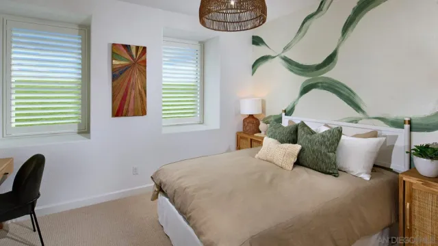 a bedroom with a bed chair and a window