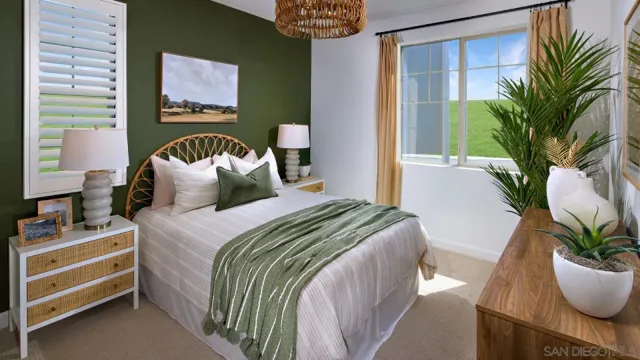 a bedroom with a bed and a potted plant