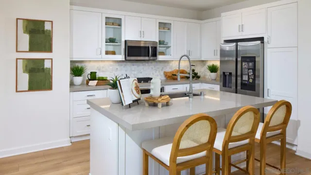 a kitchen with a table chairs appliances and cabinets