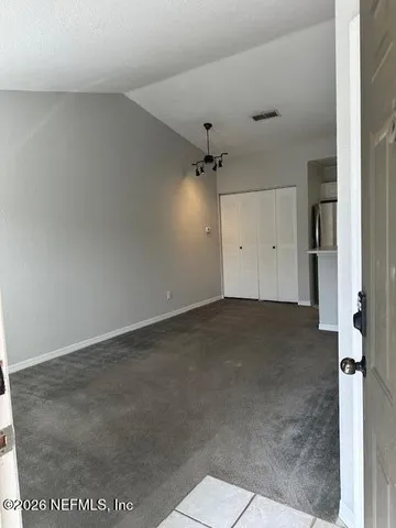 a view of a kitchen with refrigerator and a sink