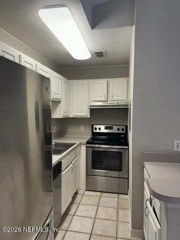 a living room with fireplace furniture and a chandelier